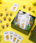 Total Vibe Bulk Sunflower Enamel Pins For Women Includes 25 Gold Yellow Flower Lapel Brooches With Thank You Cards And Tissue Wraps displayed in green gift box.