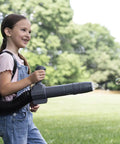 Child playing with 150BT Inspired Toy Bubble Leaf Blower, featuring air blast and lights, outdoors on a sunny day.
