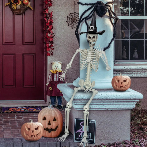 5.4Ft Life Size Halloween Skeleton With Movable Joints sitting on a porch with pumpkins, wearing a witch hat