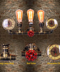 Three Lights Water Tube Wall Sconce With Retro Industrial Steampunk Style Antique Bronze Finish Red Valve Wheel Dual Roman Numeral Clocks on brick wall.