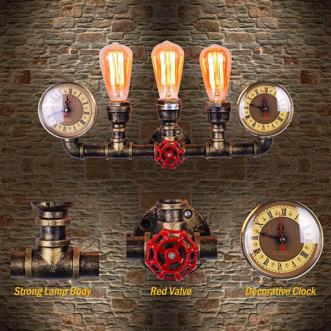 Three Lights Water Tube Wall Sconce With Retro Industrial Steampunk Style Antique Bronze Finish Red Valve Wheel Dual Roman Numeral Clocks on brick wall.