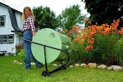 Person moving Back Porch Compost Tumbler For Small Yards And Urban Spaces With Odor Control And Fully Enclosed Design That Keeps Animals Out