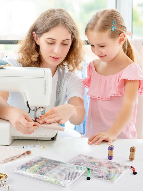 Woman sewing with child nearby, using 20 Pack Zipper Mesh Document Pouches Set, 6 By 9 Inch A5, Water Resistant Plastic File Bags.