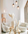Three Light Teardrop Glass Pendant Chandelier With Hand Blown Seeded Bubbles hanging in modern living room