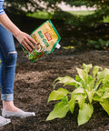 Person using Bug Geta Snail And Slug Killer 2 Slug Bait near plants, OMRI listed organic pest control for gardens, 6 lb pack in action