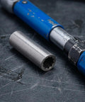 Heavy Duty Steel Shaft Coupling For Auto Lift Motors on workshop surface beside socket wrench, sturdy silver garage upgrade.