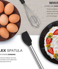 Ultimate 33-Piece Silicone And Stainless Steel Utensil Set with whisk and flex spatula, shown with eggs and whipped cream dessert