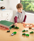Child playing with 1 To 64 Scale Die Cast Farm Toy Playset With 70 Pieces Including Tractors Trucks Farm Animals Tools A Farm Shed And More