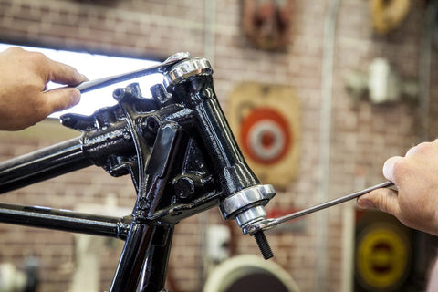 Front view of OTC 4892 steering head bearing installer for Harley-Davidson motorcycles; metal tool used on headstock.