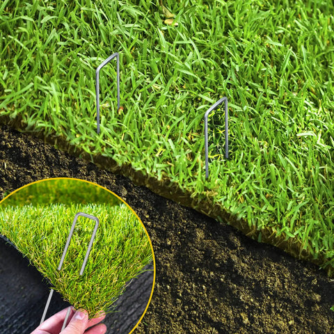 Close-up of 200 Pack 6 Inch Landscape Staples, 11 Gauge Galvanized U Shaped Garden Stakes securing grass turf