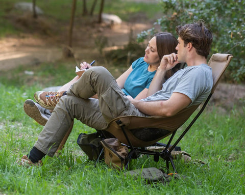 Couple relaxing on Lightweight Folding High Back Camping Chair With Head Support For Outdoor Adventures in khaki