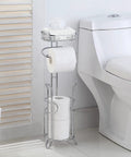 Free Standing Chrome Toilet Paper Holder With Reserve Shelf And Storage Basket next to toilet in bathroom