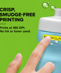 Totally Slick Bluetooth Label Maker With Free Mobile App Control, Super Handy Portable Printer For Quick Desk Organizing, Syncs Easily With Ios And Android, Includes One White Paper Tape Roll, Fresh Daydream Blue Finish showing smudge-free yellow label printing on a blue container.