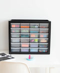 24 Drawer Plastic Storage Organizer Cabinet For Garage Tools Beads Crafts Balloons Building Bricks Stickers And Small Biz Supplies Durable Black Storage Organizer Made In USA For Easy Centralized Tidying placed on a white desk with stationary