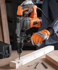 Worker using 10 Amp Rotary Hammer Drill With Vibration Control Three Modes Demolition Kit Chisels And Bits In Carry Case.