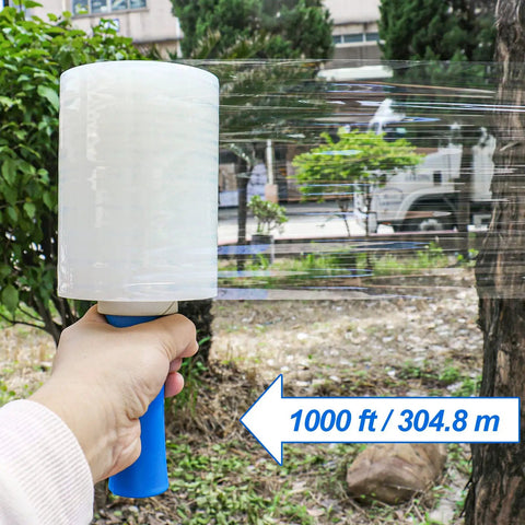 Hand holding clear industrial stretch wrap film 5 inch by 1000 feet two pack with handles for moving and packing