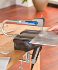 Compact Variable Speed Scroll Saw Kit Rolls Out Smooth Cuts With Automatic Blade Tensioning Detachable Handheld Coping Function Plus Dust Collection Port in use on plastic.