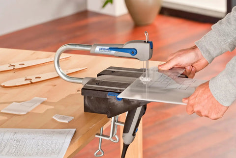 Compact Variable Speed Scroll Saw Kit Rolls Out Smooth Cuts With Automatic Blade Tensioning Detachable Handheld Coping Function Plus Dust Collection Port in use on plastic.