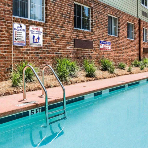 Installed Two Pack Aluminum Pool Safety Signs 10 By 14 Inches Outdoor Decor No Lifeguard On Duty Swim At Your Own Risk Never Leave Children Unattended Weatherproof Durable Pool Sign Set next to a swimming pool