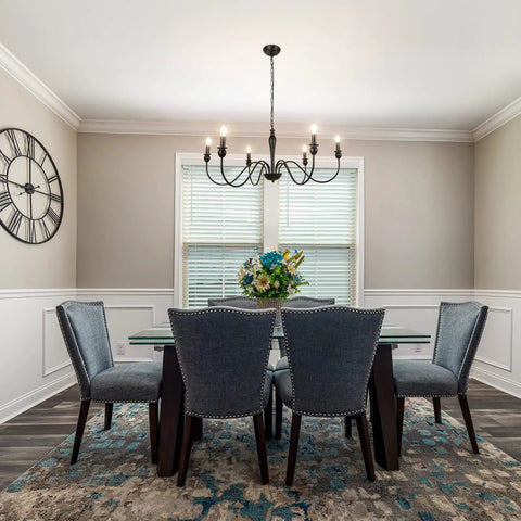 Dining room with six light black modern farmhouse chandelier and rustic vintage candle iron arms in matte black finish.
