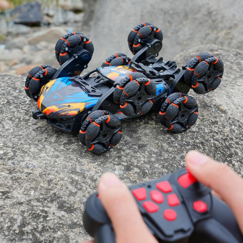 Epic 8 Wheel Hand Controlled RC Stunt Car With Gesture Sensing Remote climbing over rocks outdoors.