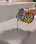 Pouring Liquid Rubber Coating Sealant on masonry step for waterproof flexible UV-resistant coating, 16 oz can visible