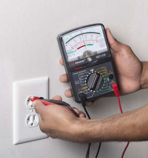 Hands using GMT 319 Multimeter Tester For Electric Pros And DIYers, RJ45 And RJ11 Ports, 7 Functions And 19 Ranges, Black at an outlet
