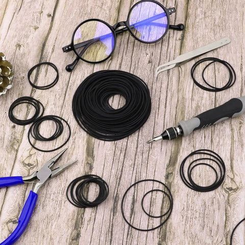 50 Pcs Cassette Recorder Rubber Belts Repair Kit 1mm Wide Fits 40 To 135mm Mix Flat Belts with tools on wooden surface