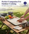 Outdoor setting with 14x10 double sided cutting board with stainless steel edge and wheat straw side on wooden table.