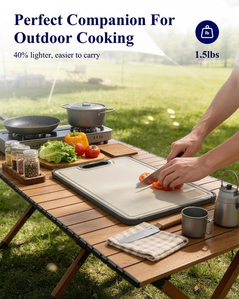 Outdoor setting with 14x10 double sided cutting board with stainless steel edge and wheat straw side on wooden table.