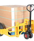 Heavy Duty All Terrain Steel Pallet Truck With Pneumatic Tires and Smooth Steering gliding with a load of cardboard boxes.