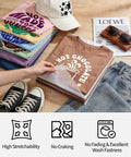 Image showing folded shirts and jeans with designs made using Vibrant 33 Sheets 12x12 Inch Heat Transfer Vinyl Kit for DIY projects.