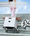 Foldable Utility Cart With Stair Climbing Wheels being pulled up stairs, showcasing collapsible rolling crate with lid, Milky White.
