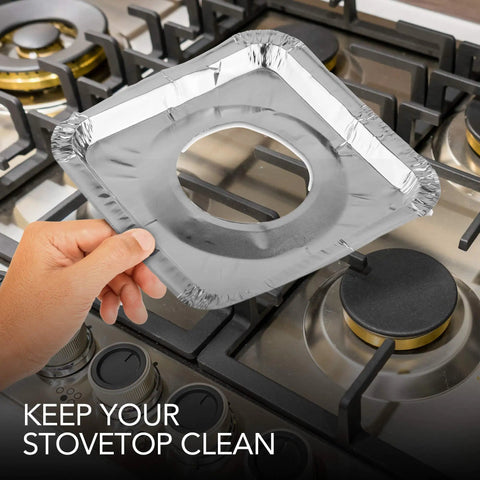 Person holding Heavy Duty Aluminum Stove Top Burner Liners 8.5 Inch 100 Pack Disposable Covers over gas range