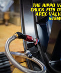 Heavy Duty Tire Inflator Gauge With Backlit Digital Readout 150 PSI Push To Lock Chuck connected to tire valve