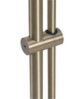 Close-up of antique brass adjustment mechanism on floor lamp with adjustable height and swivel head, classic mid century modern vibe.