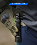 Person fastening Beast Bright 2000 Lumen Tactical Flashlight With Rechargeable Power to belt with clip, wearing tactical glove.