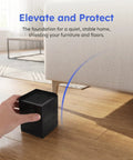 Hand holding black 2 Pack Silicone Furniture Pads For Table And Chair Legs Square 3.35 Inch Nonslip Noise Reducing Foot Pads
