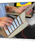 Keytar Invention Launchpad Starter Bundle For Hands On STEM Coding Learning Build Your Own Musical Instrument Kit That Lets Kids Create Code Play And Customize An Educational Instrument. child playing wooden 6-key keytar with Makey Makey