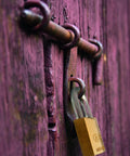 Solid Brass Padlock With Two Keys For Outdoor Use School Or Gym Lockers One And A Half Inch Wide Weather Resistant And Durable Keyed Different Built To Last For Gates Fences Lockers And Equipment on a gate