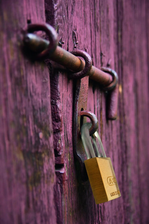 Solid Brass Padlock With Two Keys For Outdoor Use School Or Gym Lockers One And A Half Inch Wide Weather Resistant And Durable Keyed Different Built To Last For Gates Fences Lockers And Equipment on a gate