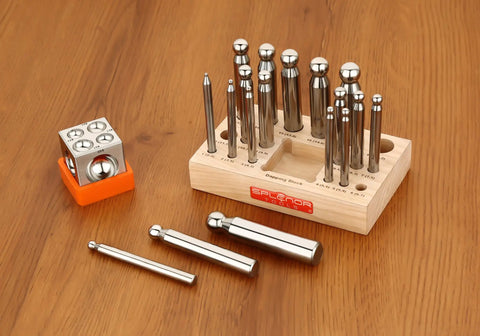 Sturdy Steel Dapping Doming Block Pro Grade 18 Punch Set for jewelry making on wooden stand, showing block and punches for metal shaping.