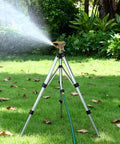 Heavy Duty Tripod Sprinkler Head Kit With 360 Degree Coverage for Lawn shown spraying water on grass with zinc alloy construction