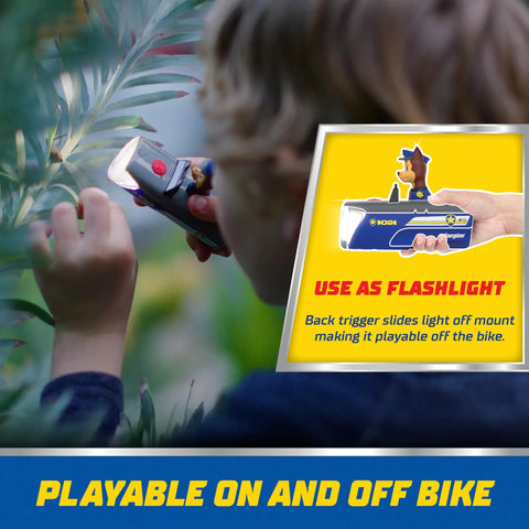 Child using Paw Patrol LED Light Gift Set flashlight outdoors, showing versatile play off bike, part of Lantern, And Bike Light Bundle For Kids
