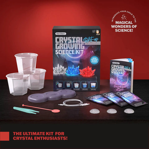 Glow In The Dark Crystal Growing Kit For Kids Ages Eight To Twelve With LED Light Up Display Grow Red Blue And Clear Crystals And See Them Glow A Totally Hands On STEM Toy Gift For Boys And Girls. Kit contents on table