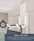 Over The Door Stroller Hanger No Drill Heavy Duty Metal Holds 50 Lb Adjustable Arms For Hallways Garages And Entryways Stroller Hook Keeps Your Stroller Off The Floor With Easy Access Storage StrollAway Inspired By StrollerBuddy mounted on a door with a stroller handle.
