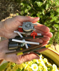 Hands holding various micro-drip tools for Drip Irrigation Cutter Tool For One Quarter Inch Micro-Drip Tubing Quick Safe Slice