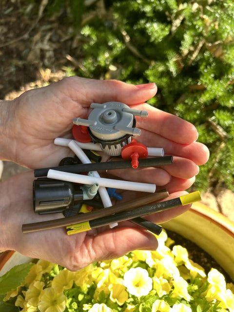 Hands holding various micro-drip tools for Drip Irrigation Cutter Tool For One Quarter Inch Micro-Drip Tubing Quick Safe Slice
