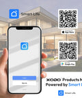 Smart Life app login screen displayed on smartphone in front of modern house, QR codes for downloading app visible