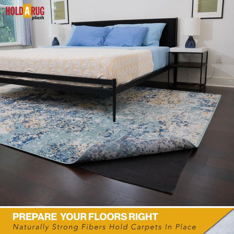 Nonskid Rug Pad 3' x 5' Plush Reversible Gripper One Quarter Inch Thick under area rug on hardwood floor in bedroom.